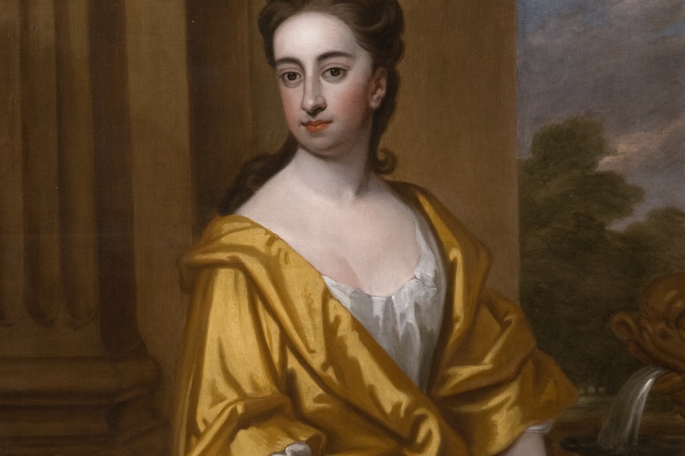 Painted portrait of a lady, Miss Cotton of Madingley, who is shown seated wearing a yellow dress