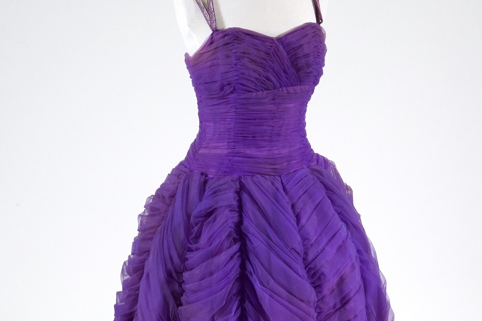 Photograph of a purple dress with straps and full skirt