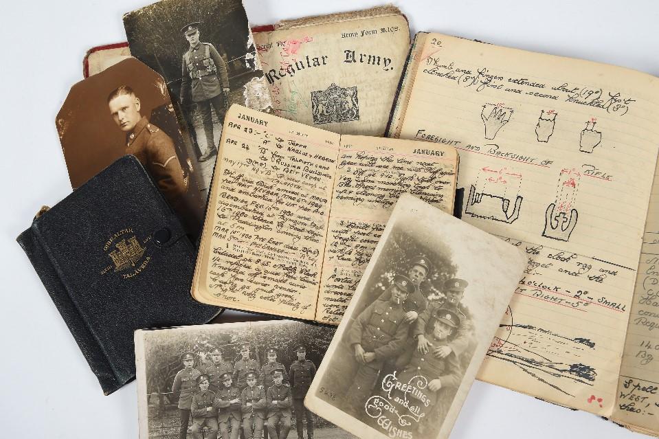 documents arranged on a white background with photograph depicting a group of soldiers at the front