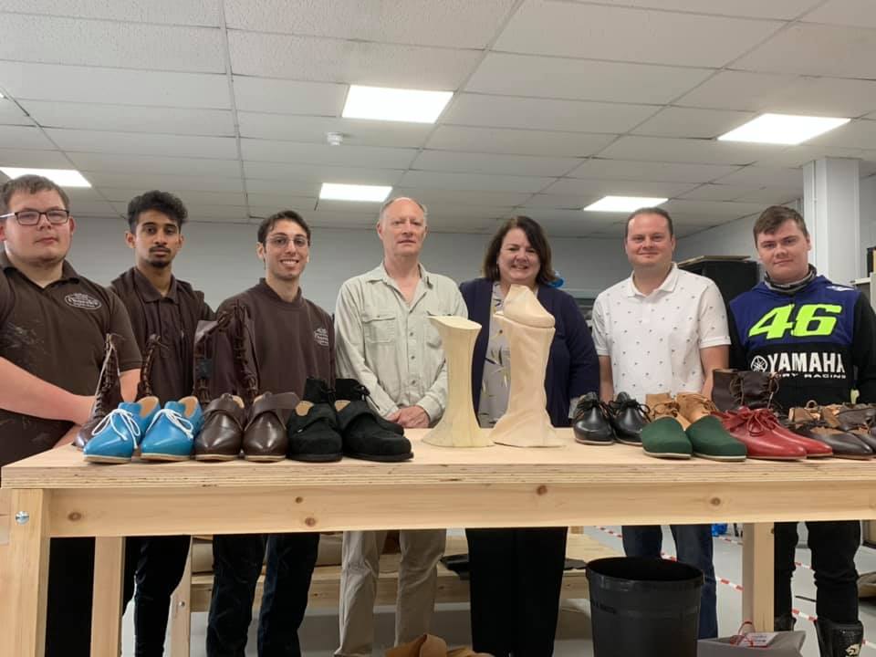 Shoemaker Andy Burke with apprentices from Churc's at Northampton College with  apart made pair of Venetian chopines