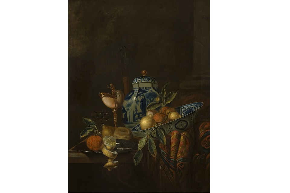 A blue and white bowl and vase with fruit in the bowl. Still life painting.