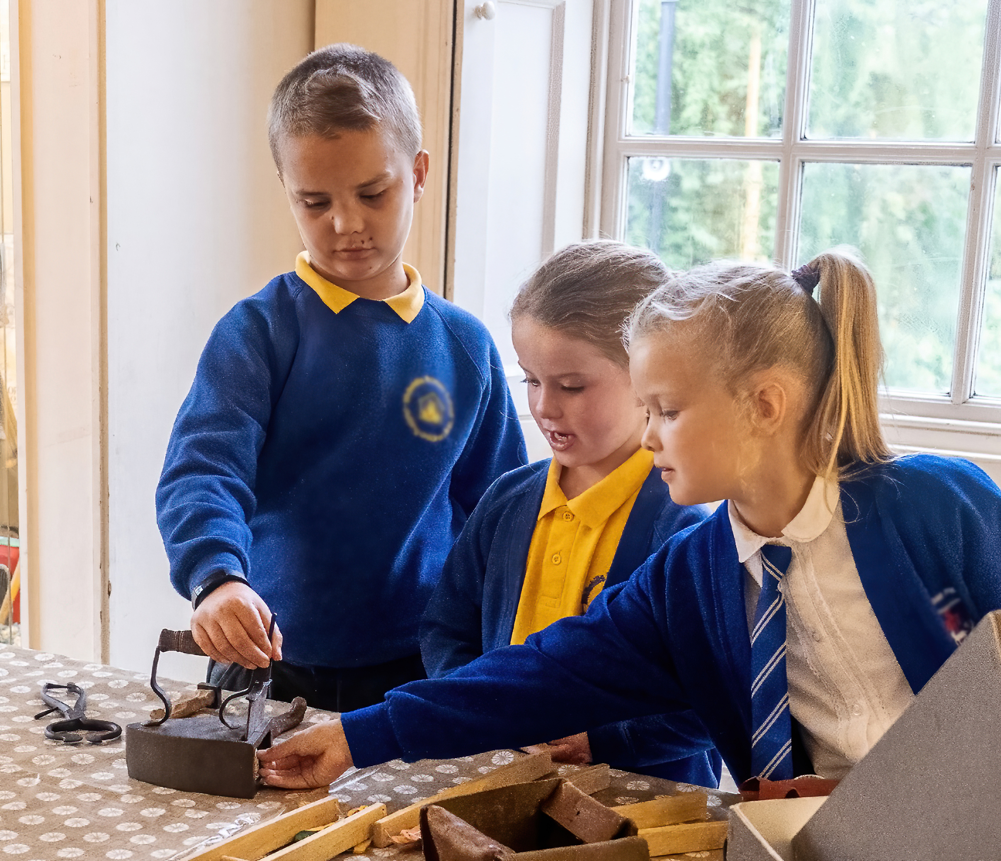 School children handling museum objects.