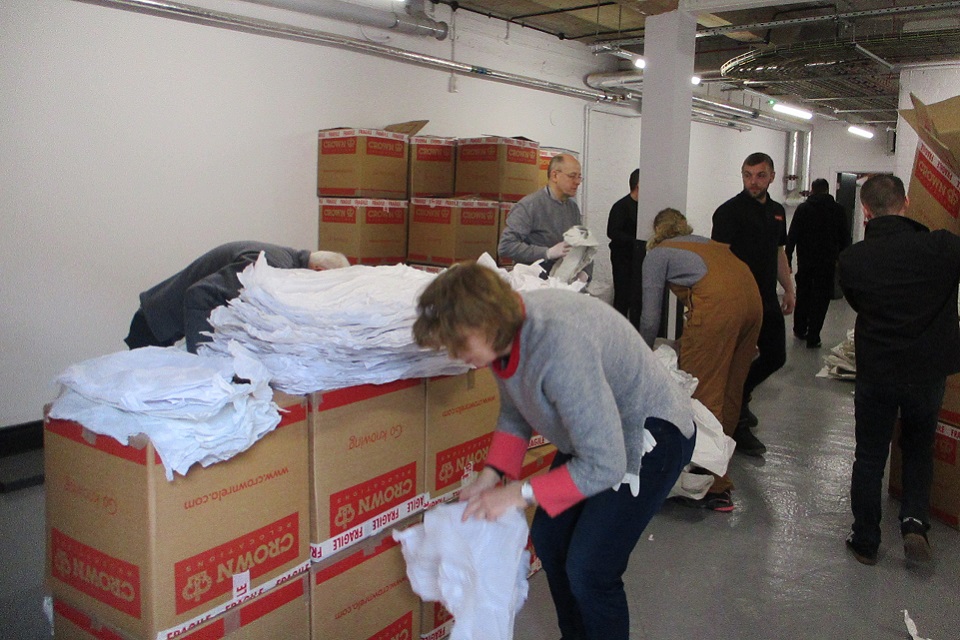 Figure smoothing tissue from boxes. Card boxes in background.