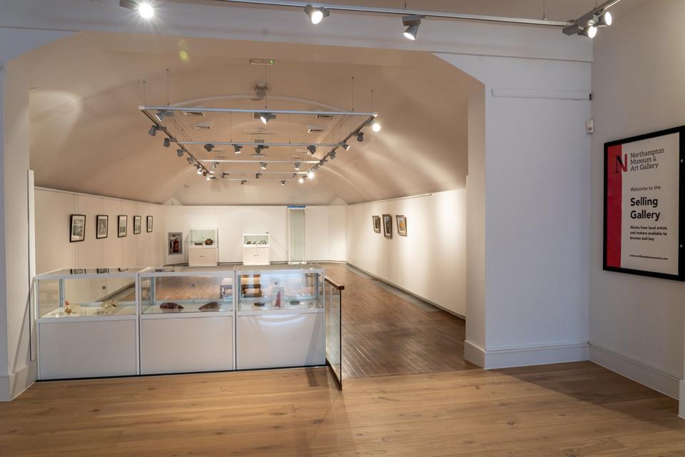 Looking through white internal arch into gallery space.