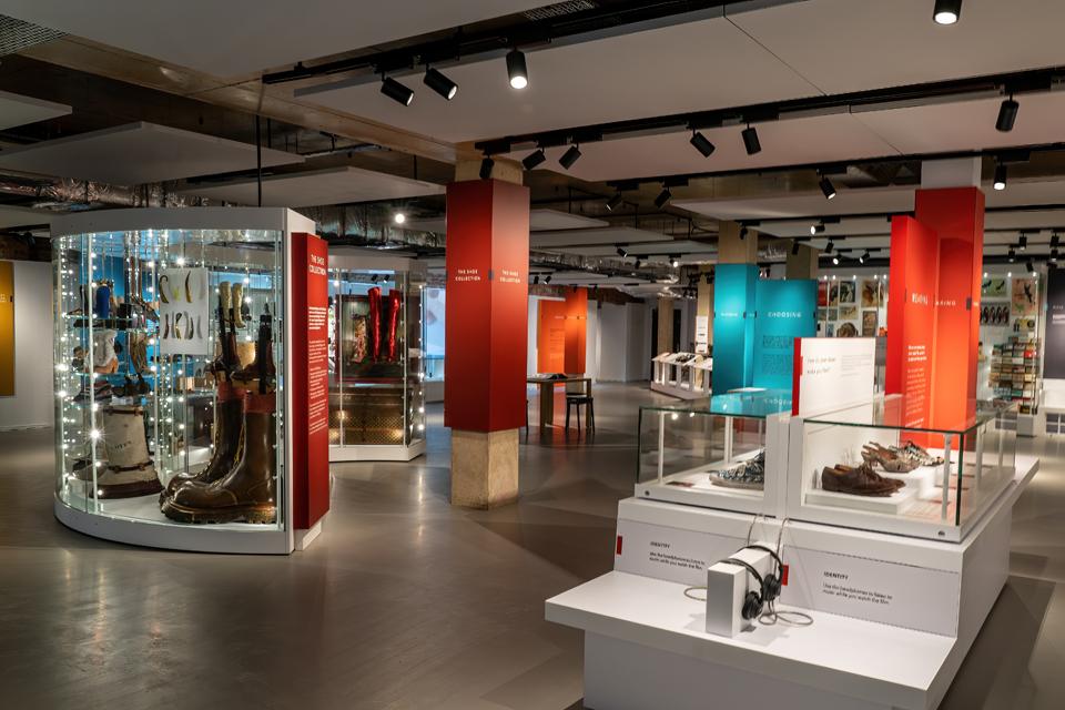 Image looking into shoe gallery with variety of display cases filled with shoes