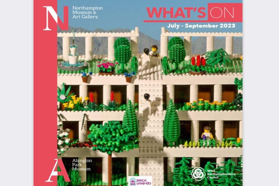Front cover of our whats on guide with a red stripe down the left and a colourful image of the hanging gardens of Babylon out of lego.
