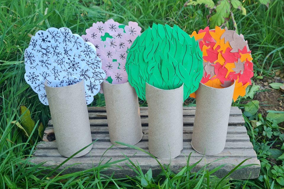 Colourful soft felt trees on a green material background.