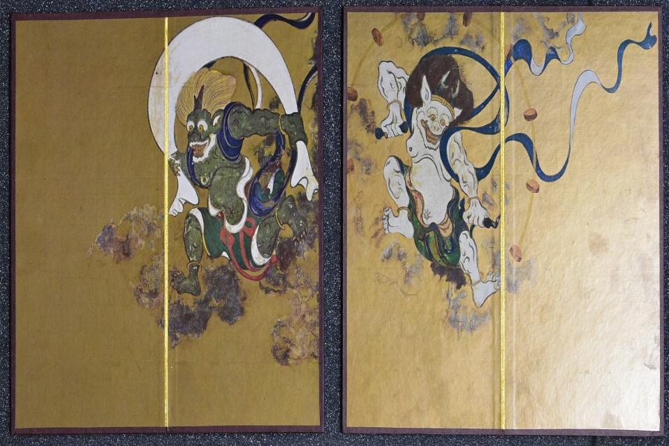 Gold imange depicting folded out screen, Flying figure with white surround to left and smaller figure to right. Colourful depictions.