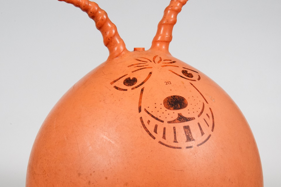 Orange bouncy rubber Spacehopper, 1970s play top made in Northampton.