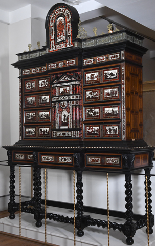 A tall and ornate ebony cabinet known as Spanish Royal Papeleiro cabinet, designed by Diego de Medina