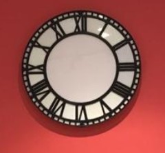 White clock face with black edging and black Roman numerals.