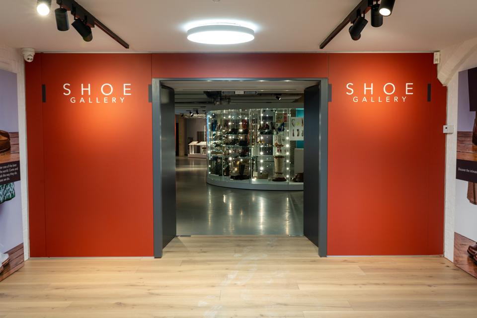 Red framed doorway surrounding entrance into a gallery with objects and display cases.