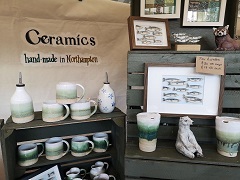 Ceramic bottles and other items on a stall.